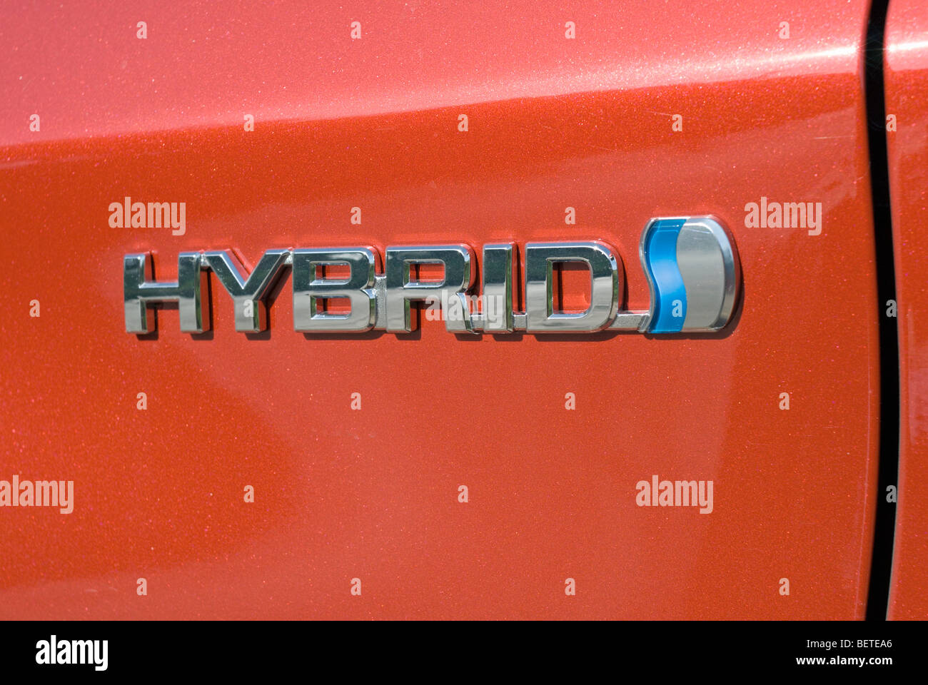 A tag on the side of a Toyota Prius reads HYBRID Stock Photo