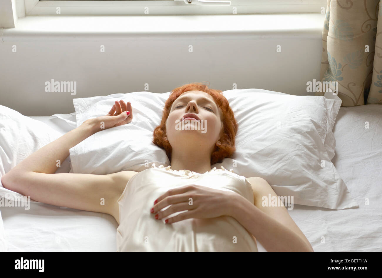 woman asleep on bed Stock Photo
