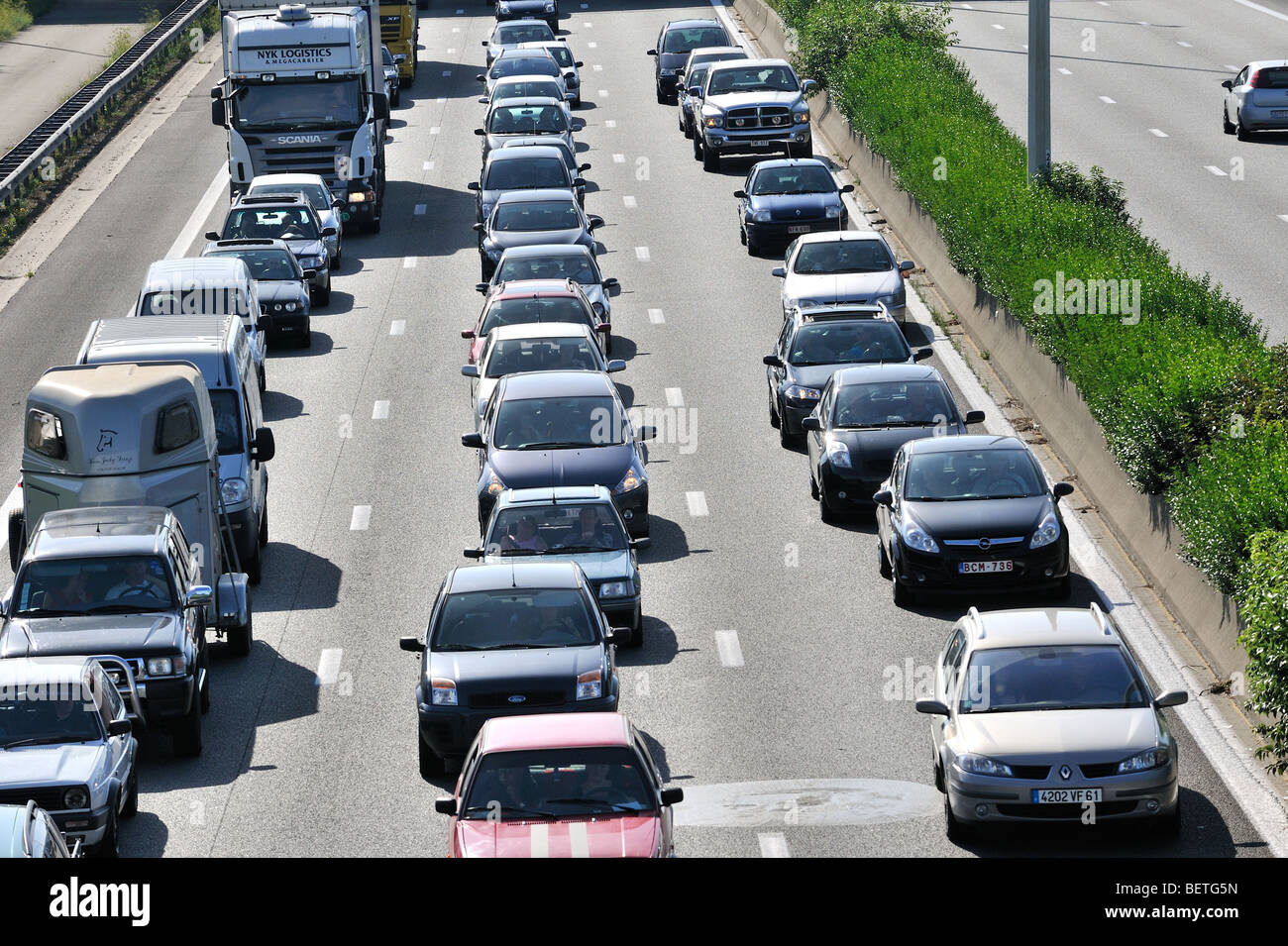 Cars queueing in highway lanes during traffic jam on motorway during summer holidays, Belgium Stock Photo