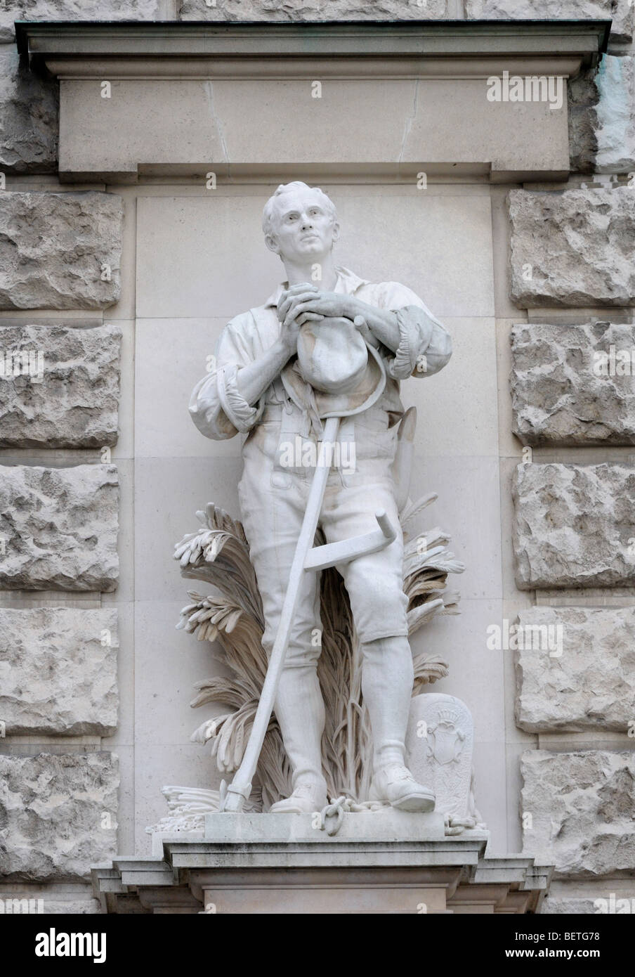 Vienna, Austria. Heldenplatz. Stone statue on the facade of the Neue Burg: Farmer with broken chains - abolition of Serfdom 1848 Stock Photo