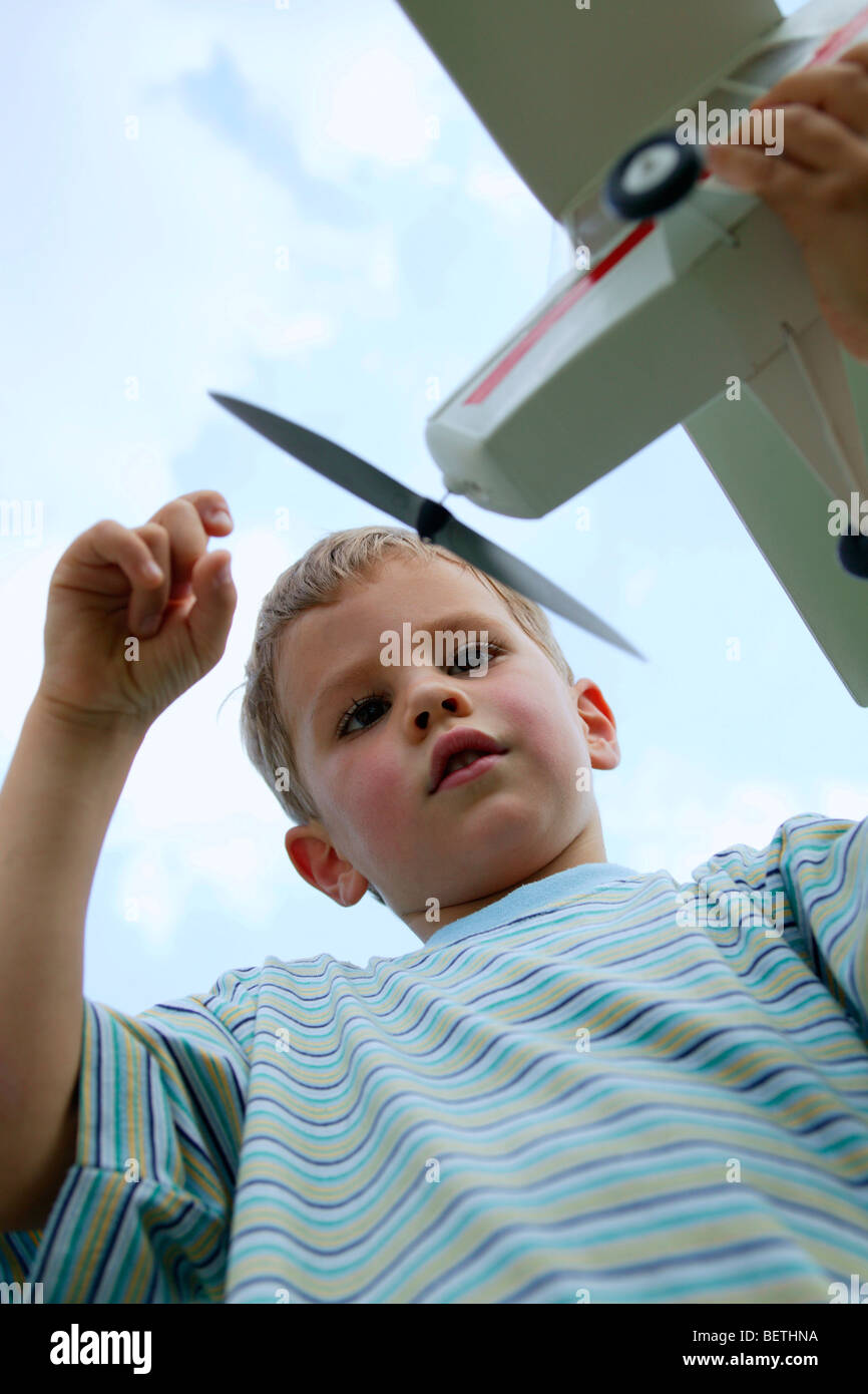 young boy outdoors playing with his toy airplane Stock Photo - Alamy