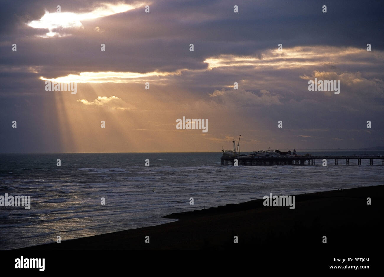 Sunlight breaking through storm clouds overlooking the English Chanel at Brighton on the south coast Stock Photo