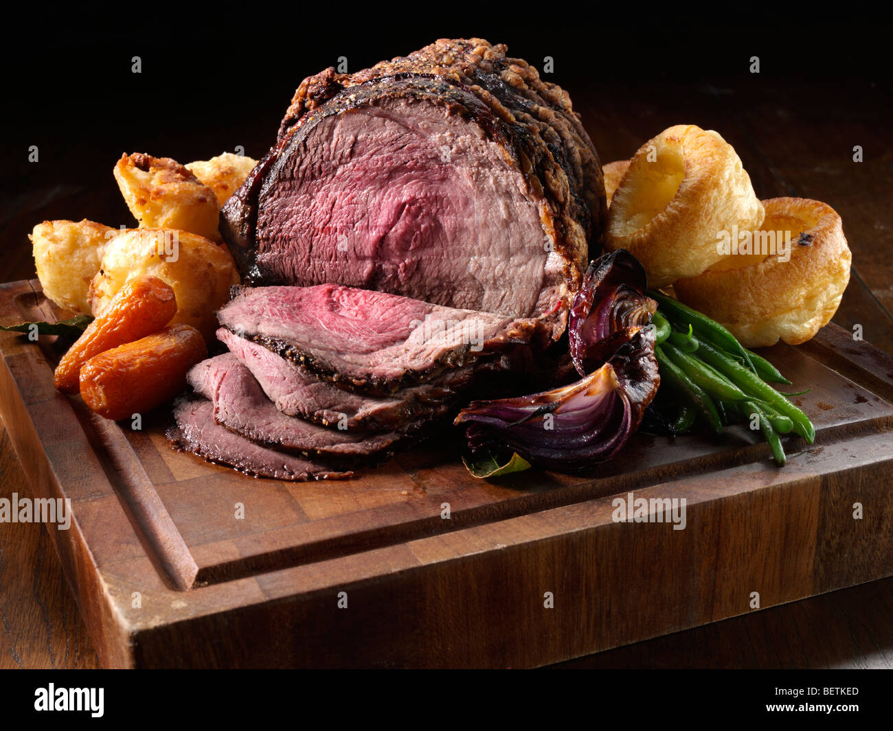 Irish roast beef topside joint with vegetables on a carving board Stock Photo Alamy