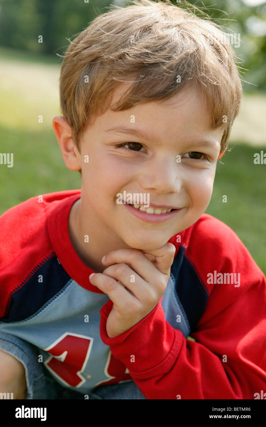 head shot of a young boy outdoors looking content Stock Photo - Alamy