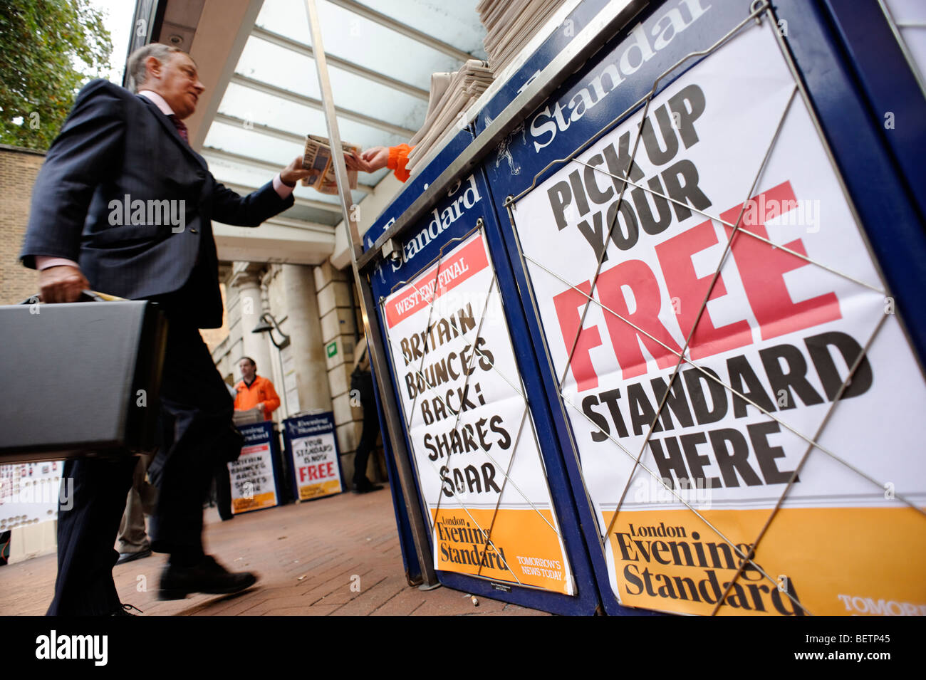 Person taking a free copy of the London Evening Standard newspaper. Central London. Britain. UK Stock Photo