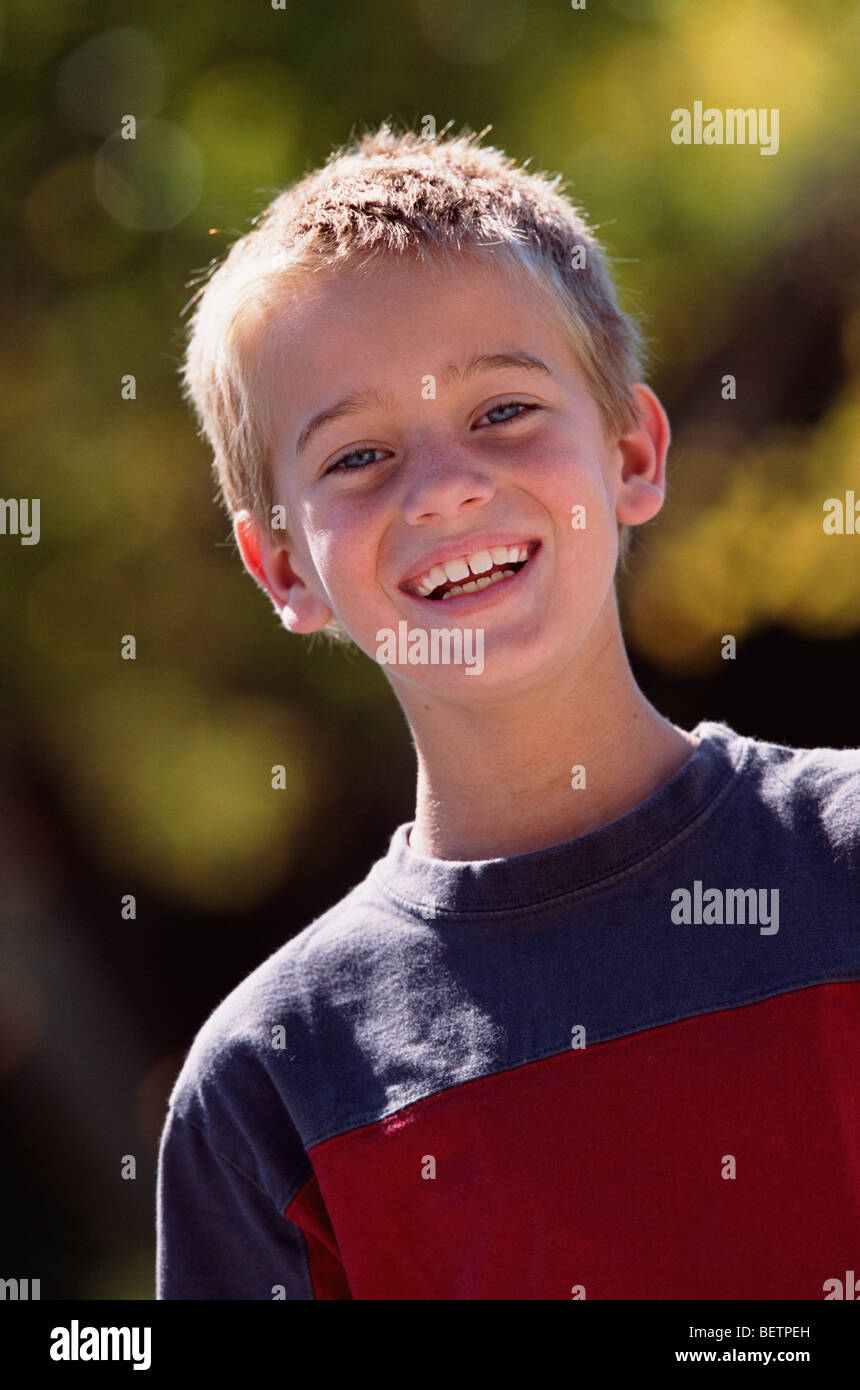 portrait of a young boy outdoors smiling at the camera Stock Photo - Alamy