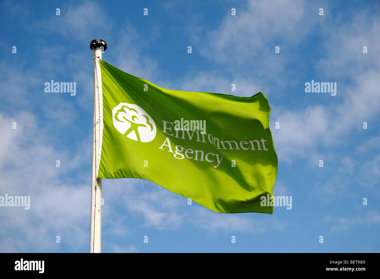 A green Environment Agency flag flying above Teddington Lock, UK. Stock Photo