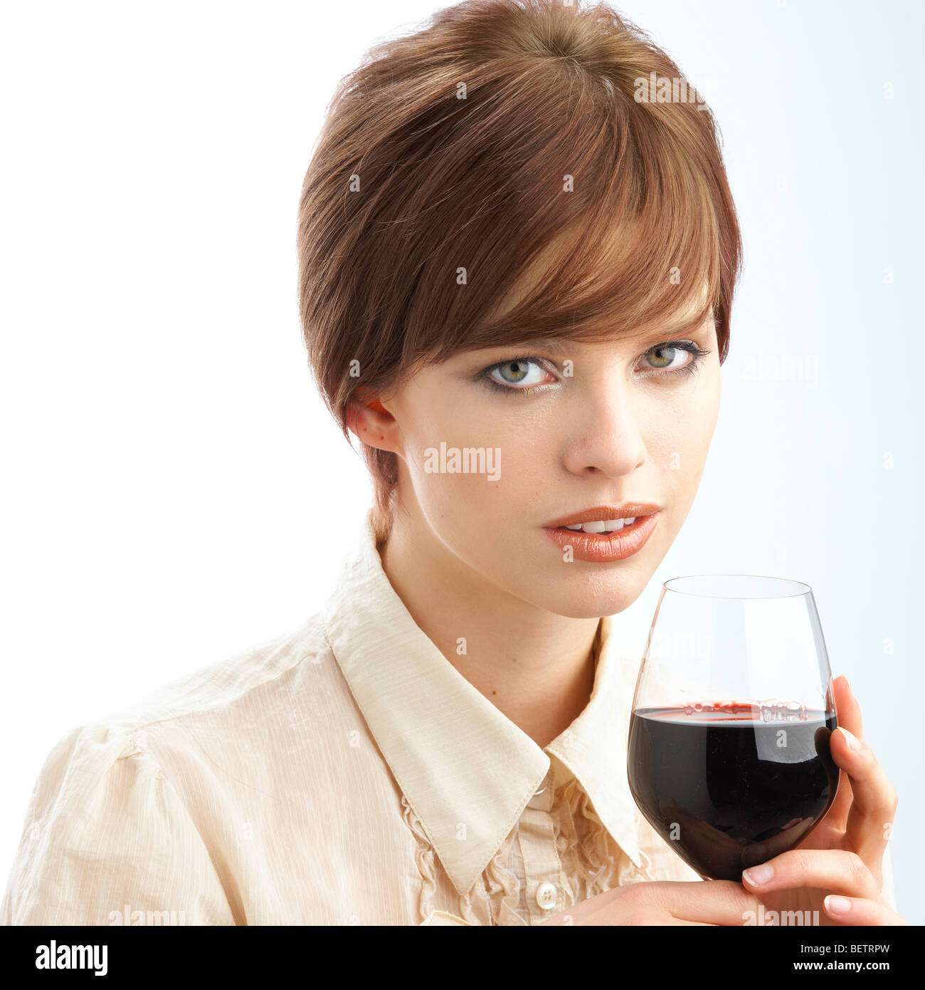 Young woman holding glass of red wine Stock Photo - Alamy