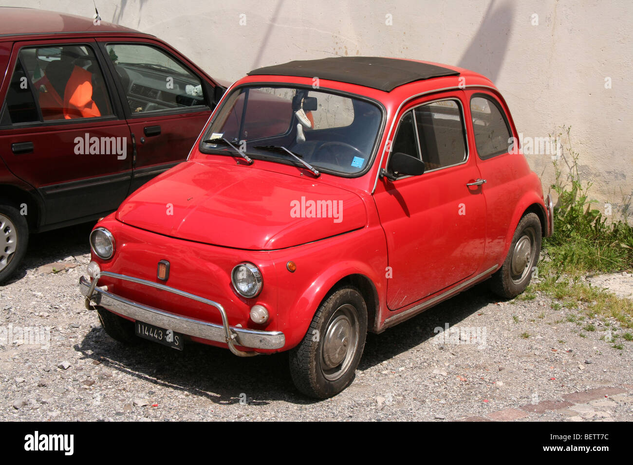 Bright red Fiat 500 bambino in an Italian alpine village Stock Photo