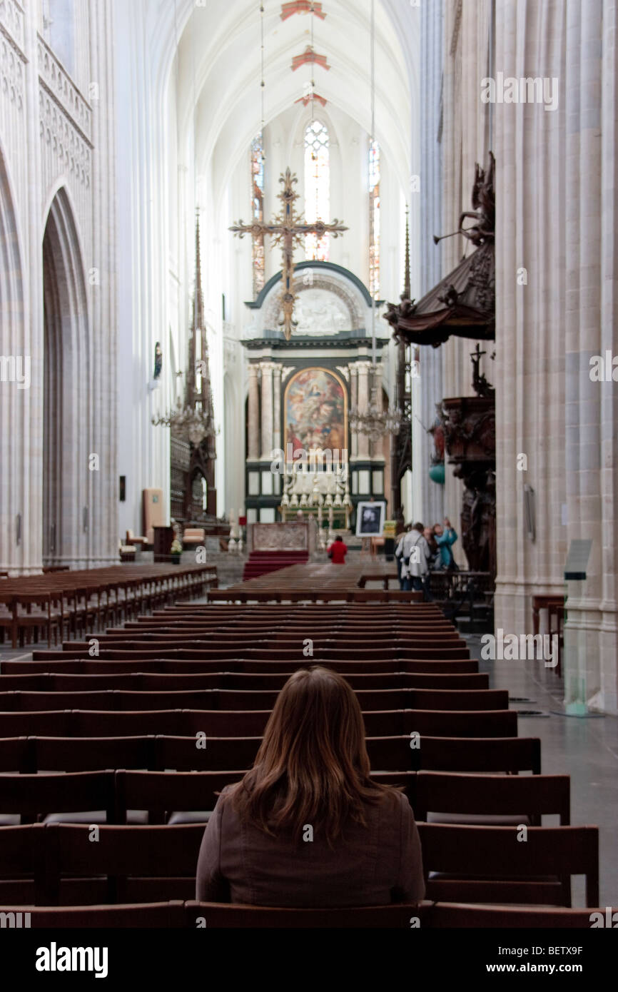 Woman is praying in church Stock Photo