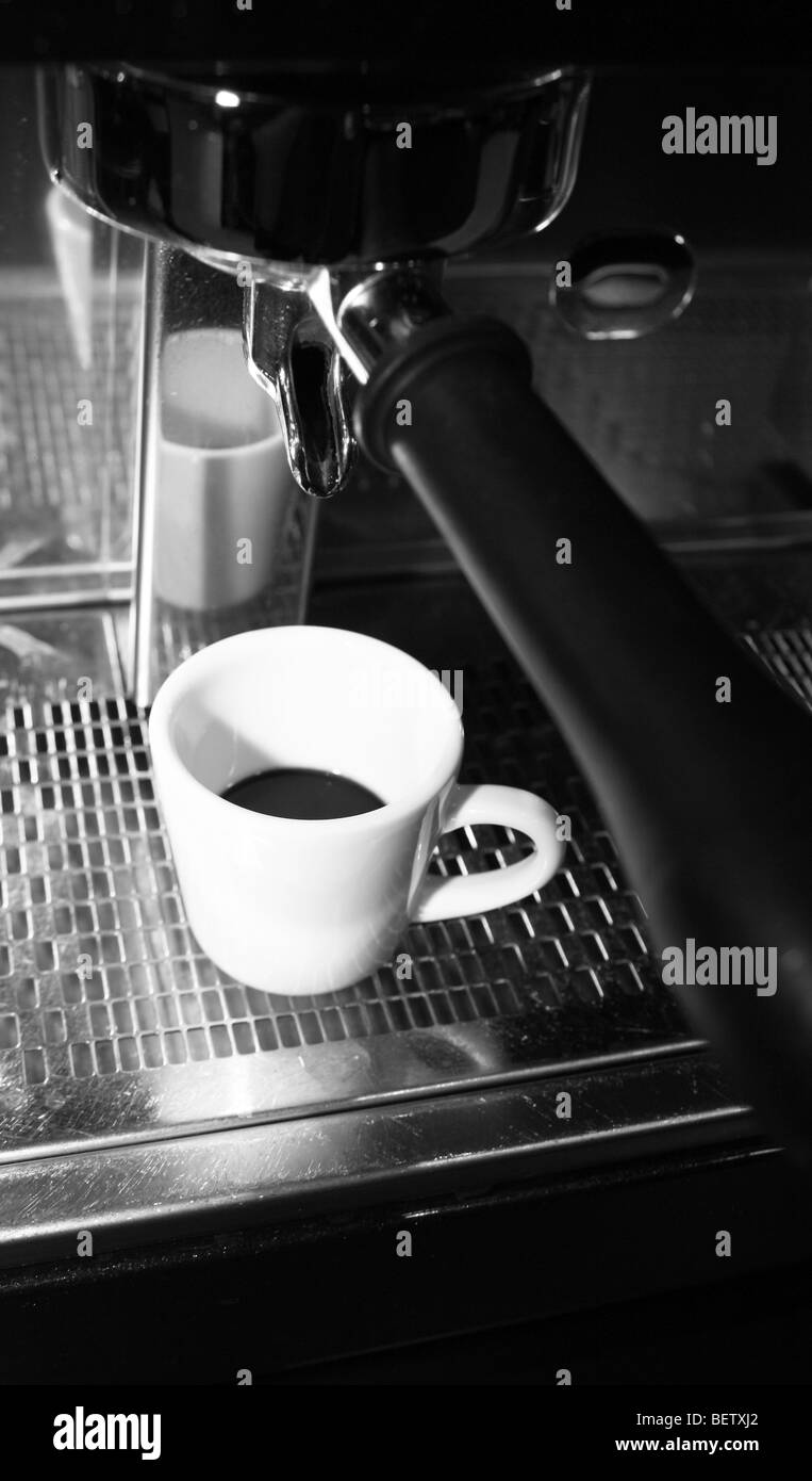 Freshly ground coffee being dispensed by a coffee machine Stock Photo