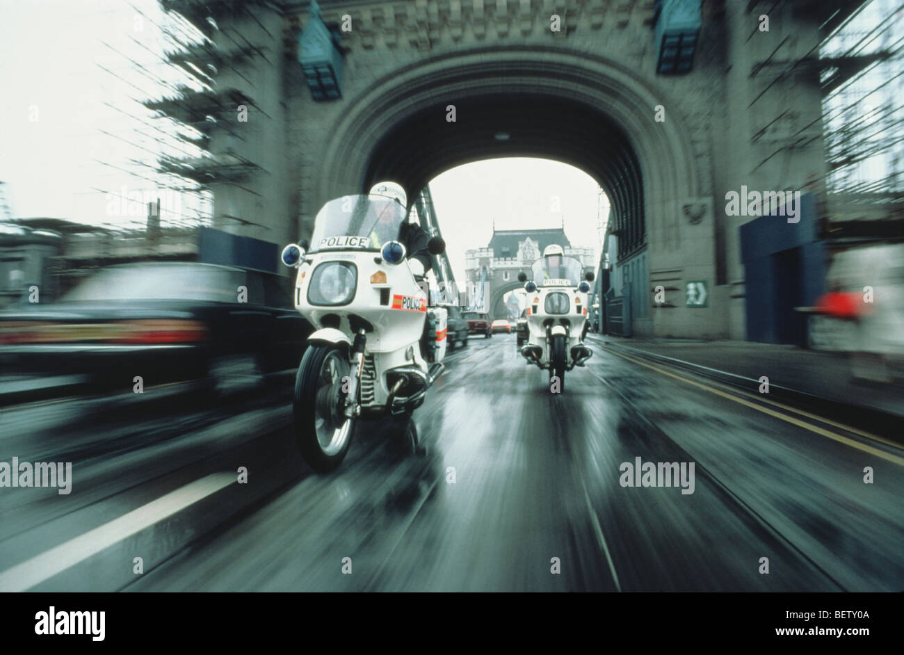 Police motorbikes riding over Tower Bridge Stock Photo