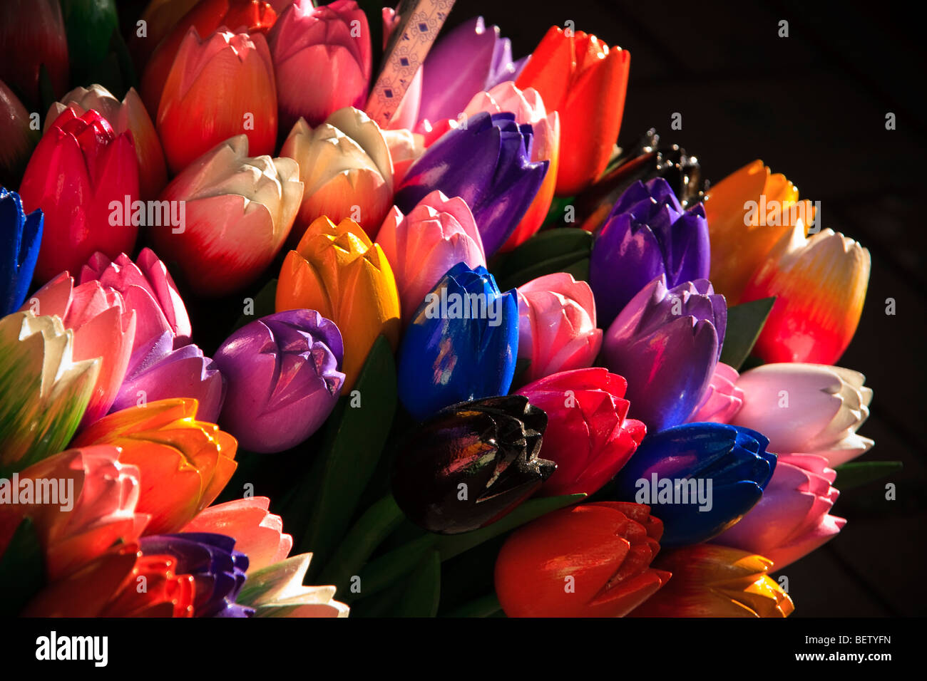 A display of tulips carved out of wood at a market in Amsterdam Netherlands Stock Photo
