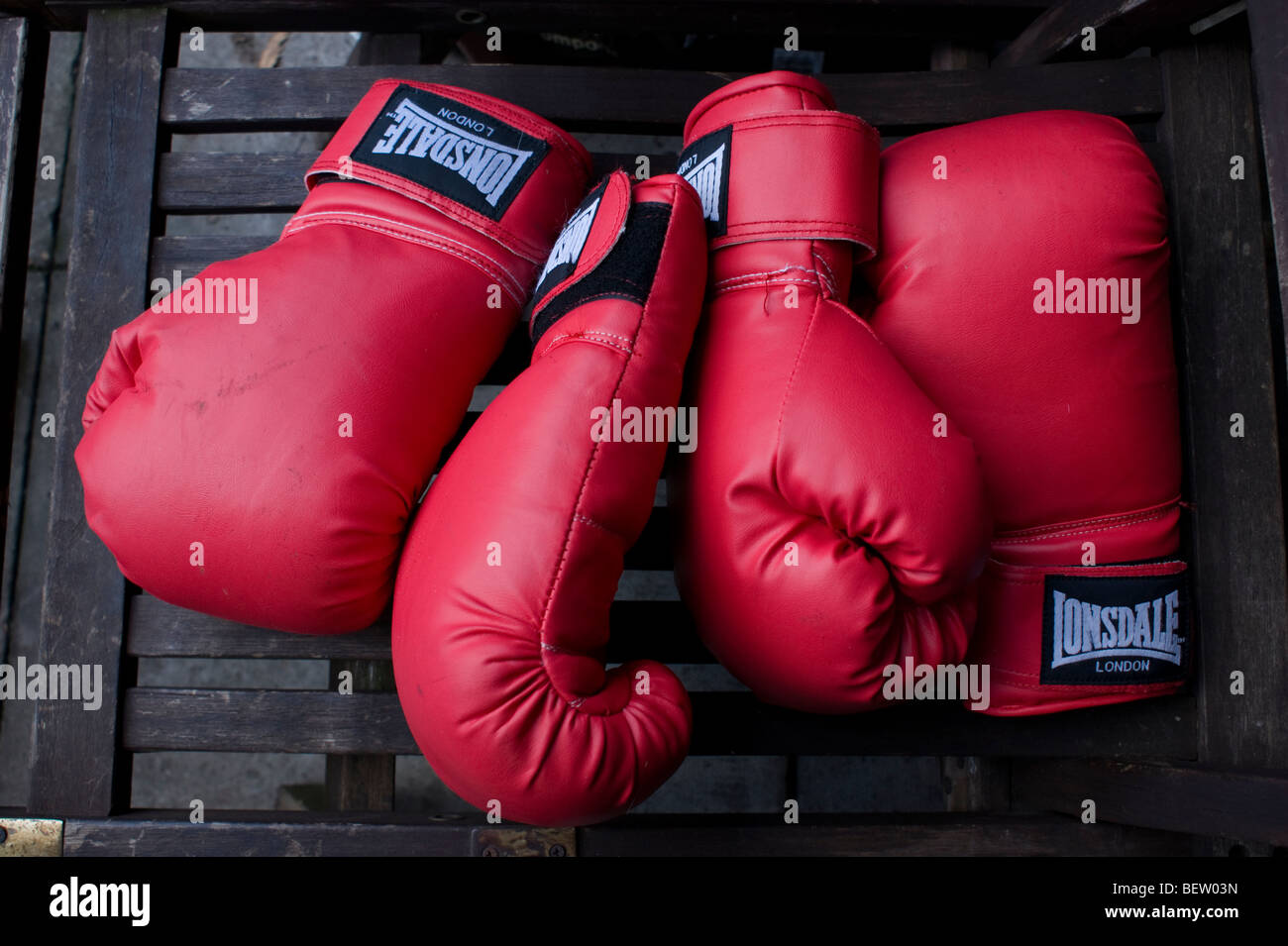 Two pairs of boxing gloves on a garden seat in North London Stock Photo -  Alamy