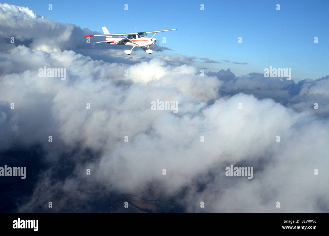 Light aircraft flying above the clouds Stock Photo - Alamy