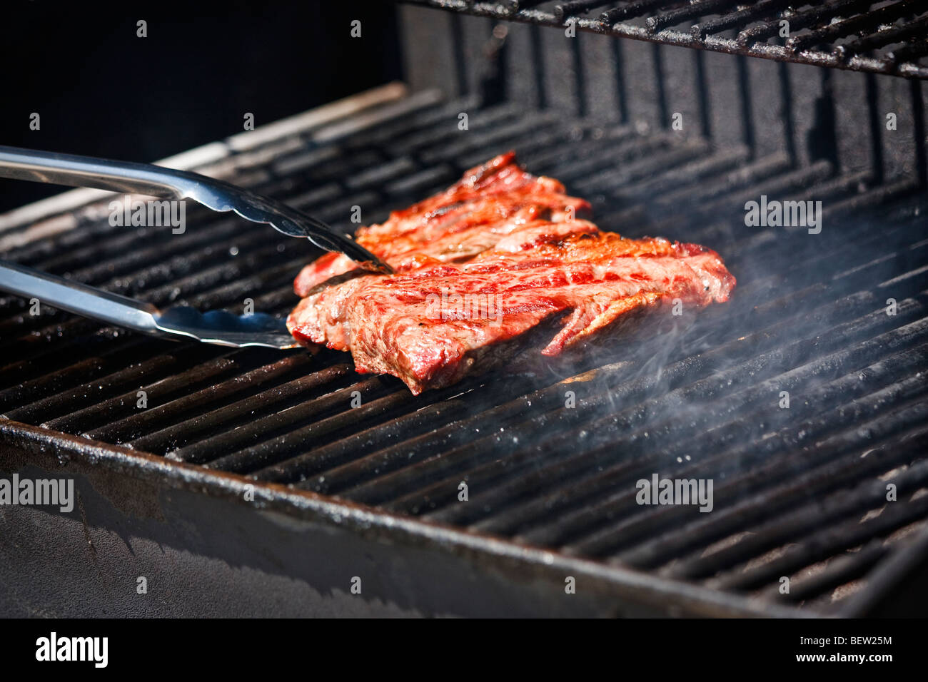 Grilling beef steak Stock Photo