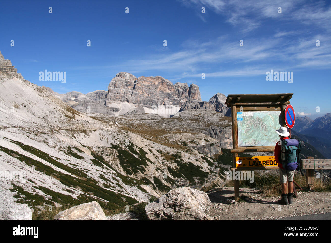 Walker at map board near Rifugio Auronzo in the Italian Dolomites Stock Photo