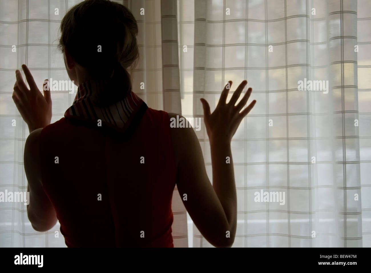 Woman looking out window Stock Photo