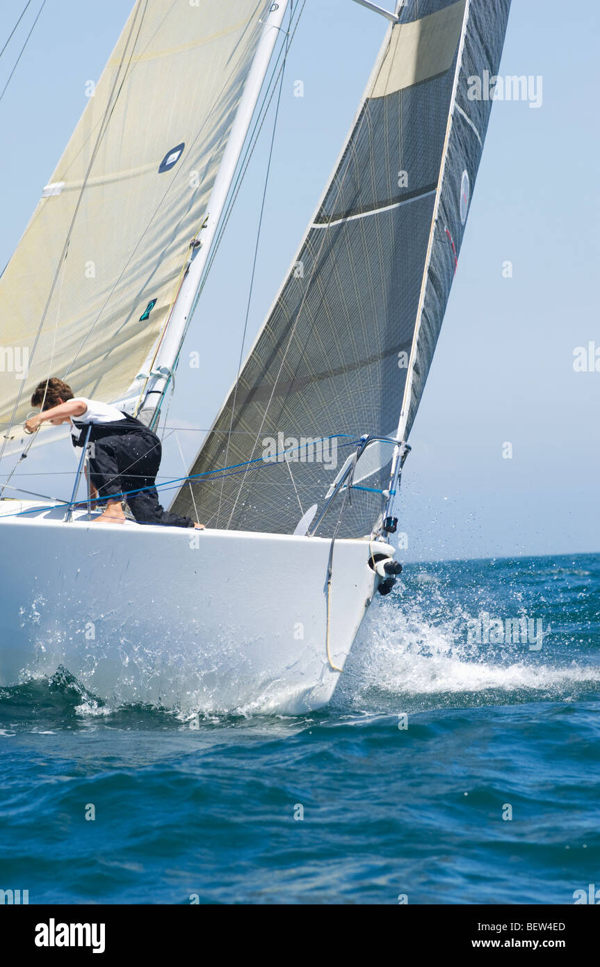 Crew member on board yacht competing in team sailing event, California Stock Photo