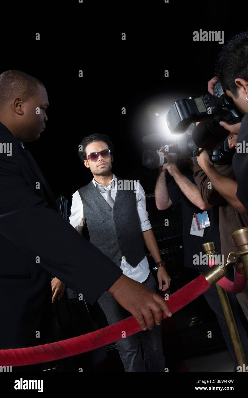 Male celebrity arriving at media event Stock Photo