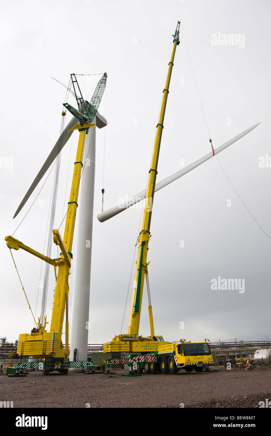 Blades being lifted by crane for fitting on Nordex N90 wind turbine under construction at