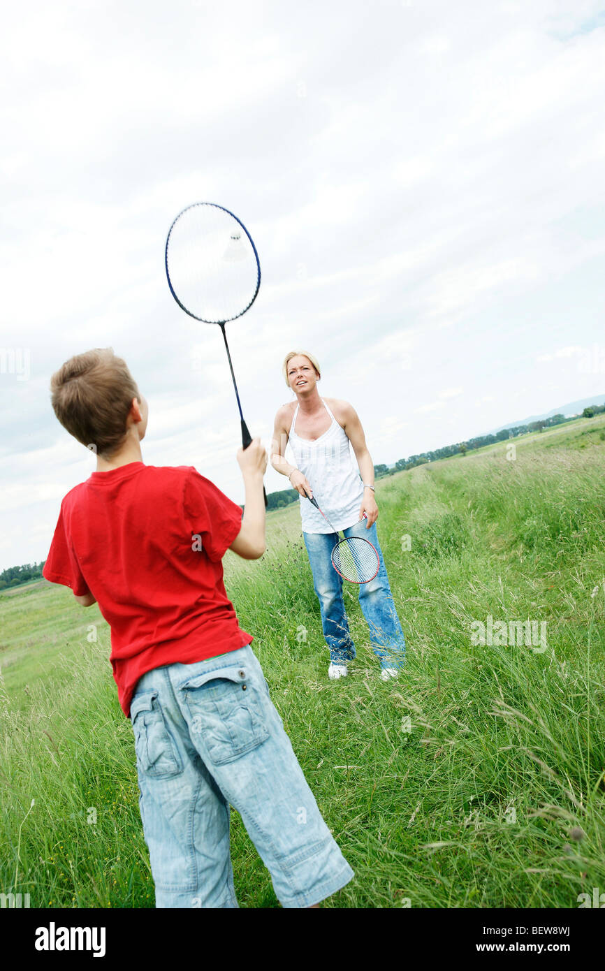 Mother and son playing badminton on a meadow Stock Photo