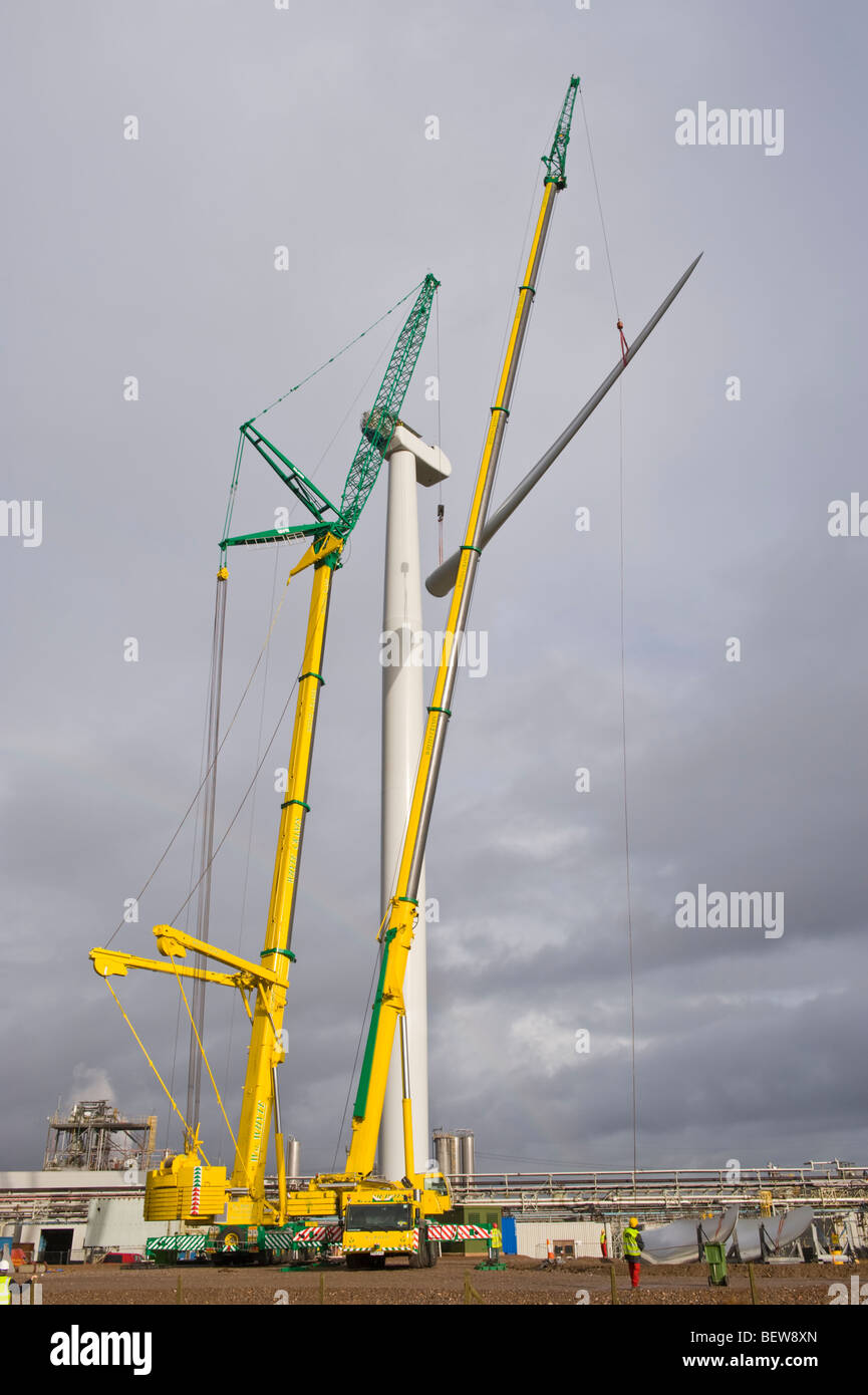 Blades being lifted by crane for fitting on Nordex N90 wind turbine under construction at