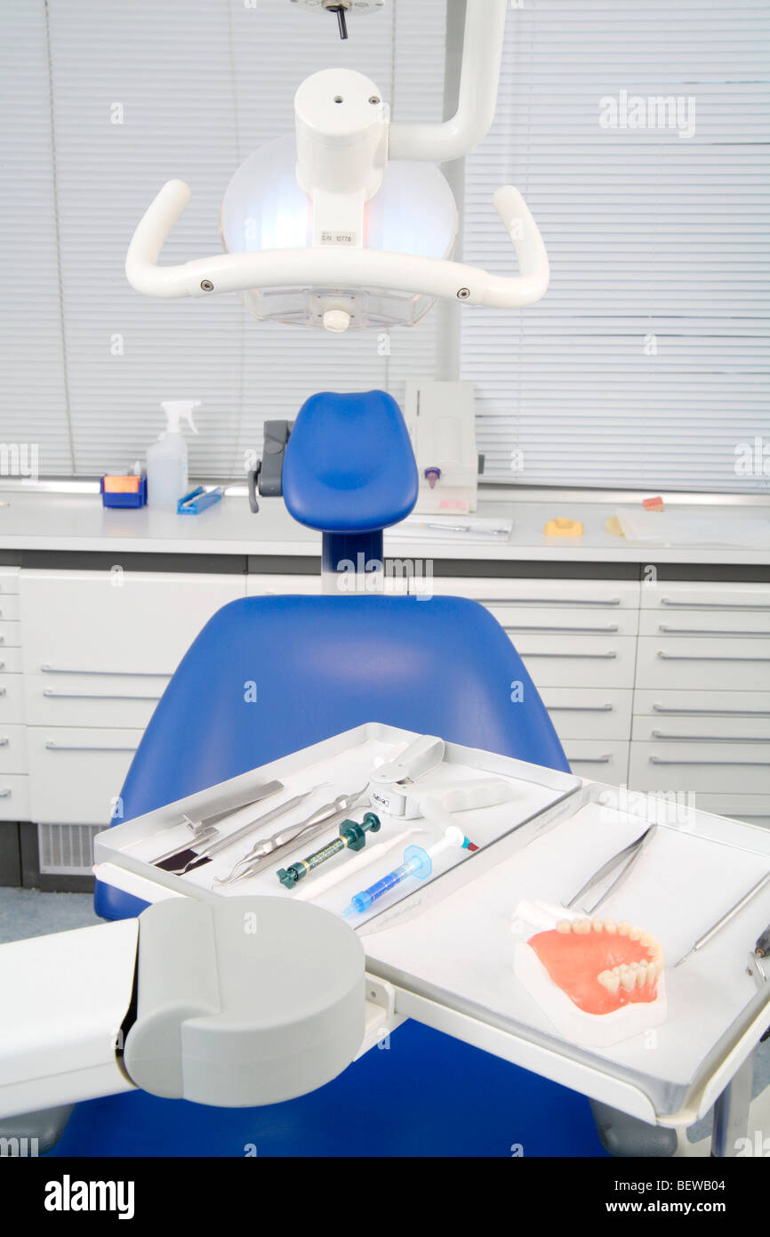 Dental chair and surgical instruments in a dental surgery Stock Photo