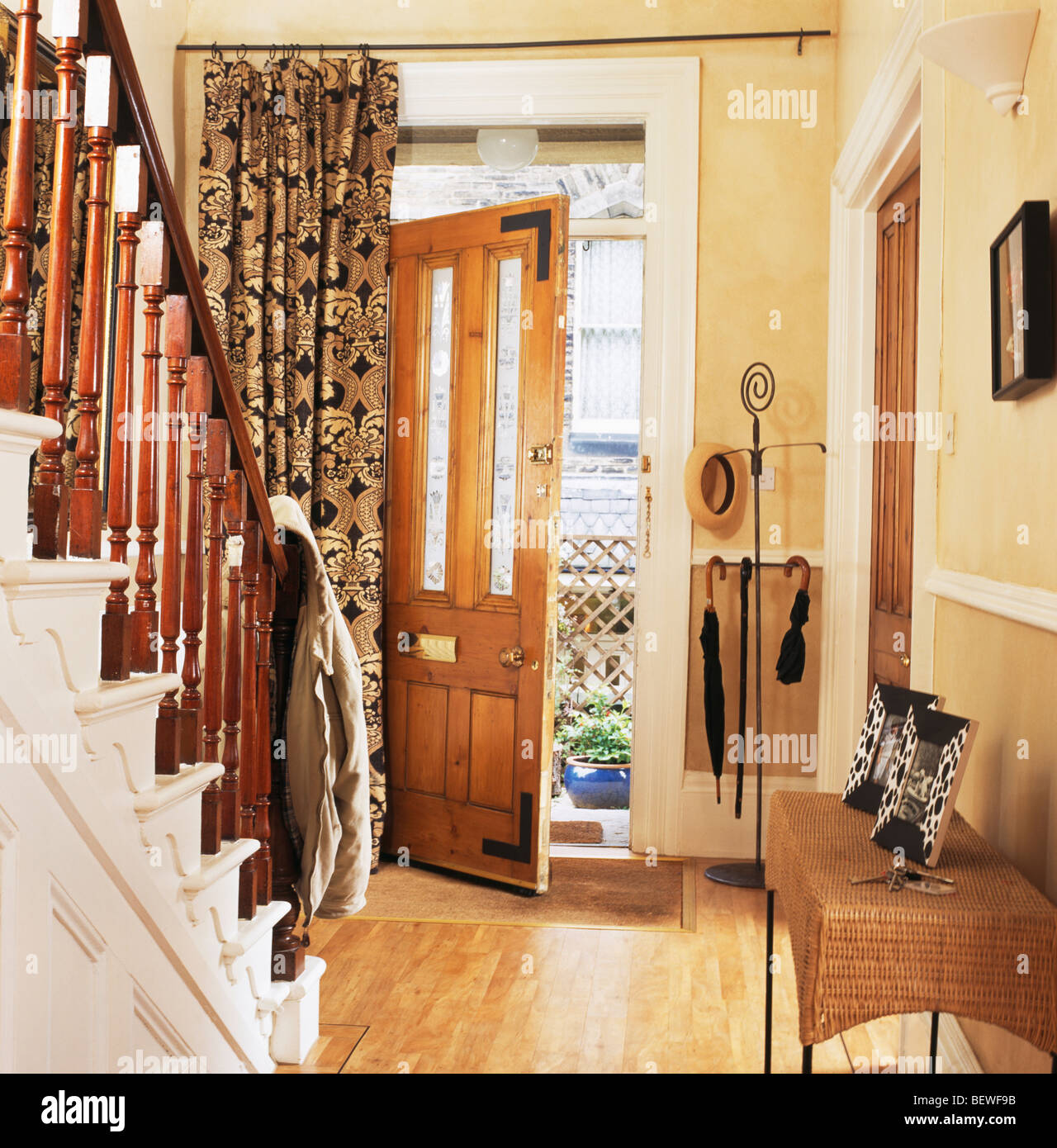 Black Gold Curtain At Open Front Door In Traditional Cream Hall