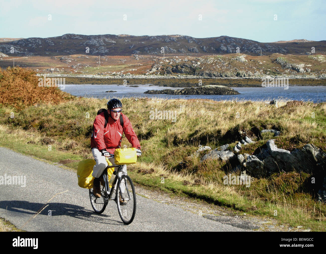 Cycling to the ferry pier from the village of Arinagour on the island of Coll, Scotland Stock Photo