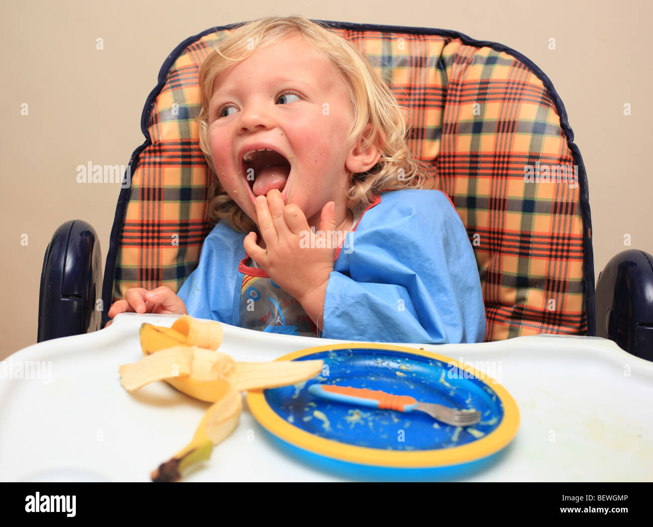 Toddler in highchair having lunch Stock Photo Alamy