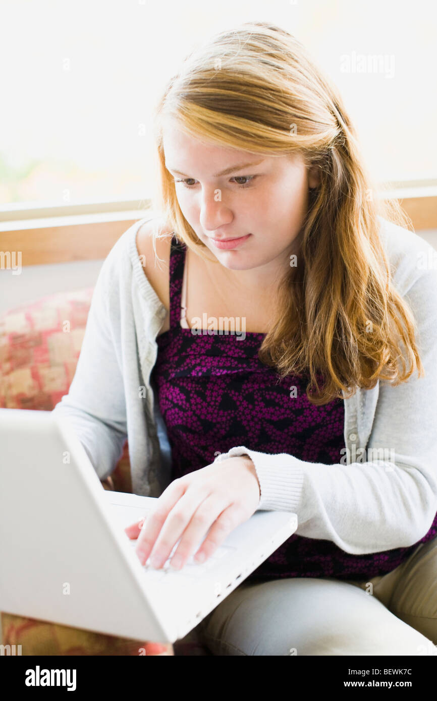 Teenage girl working on a laptop Stock Photo