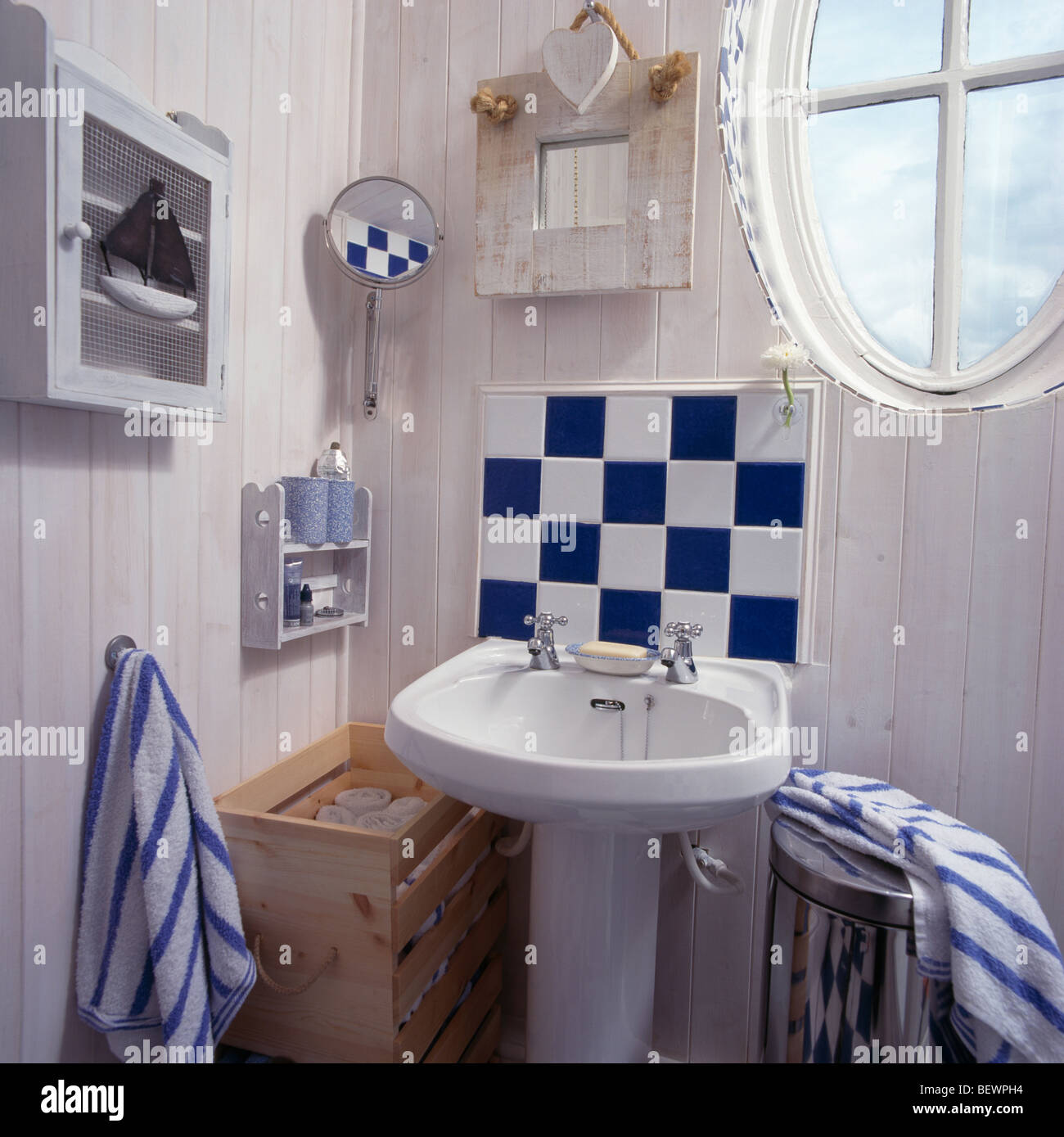 Blue White Tiles Above White Pedestal Basin In Small Seaside Themed Bathroom With Lime Washed Panelled Walls Stock Photo Alamy