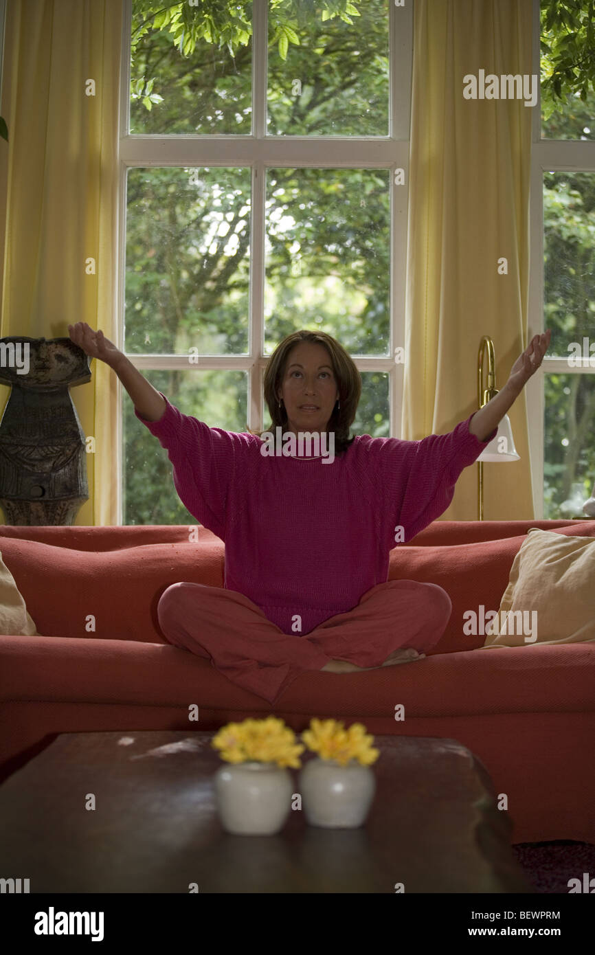Woman in yoga lotus position , meditation at home Stock Photo - Alamy