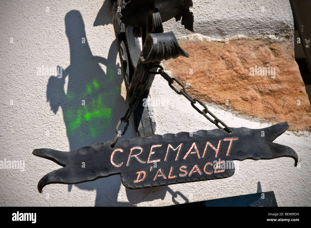 CREMANT D’ALSACE  Silhouette and ornate signage of local speciality 'Cremant d'Alsace' bottle at entrance to winery in Kaysersberg Alsace France Stock Photo