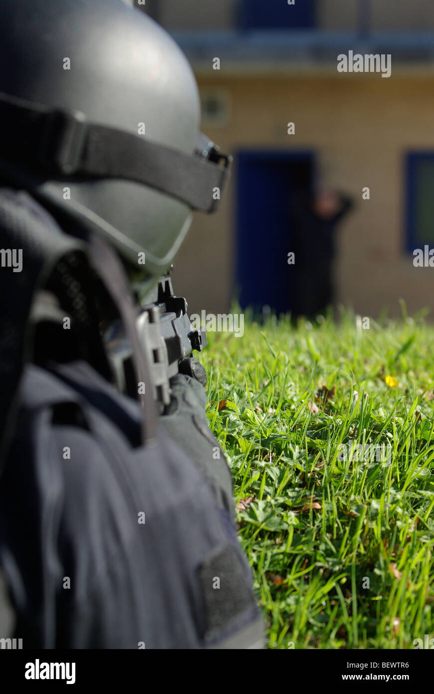 Police tactical firearms officer in containment covering subject Stock Photo