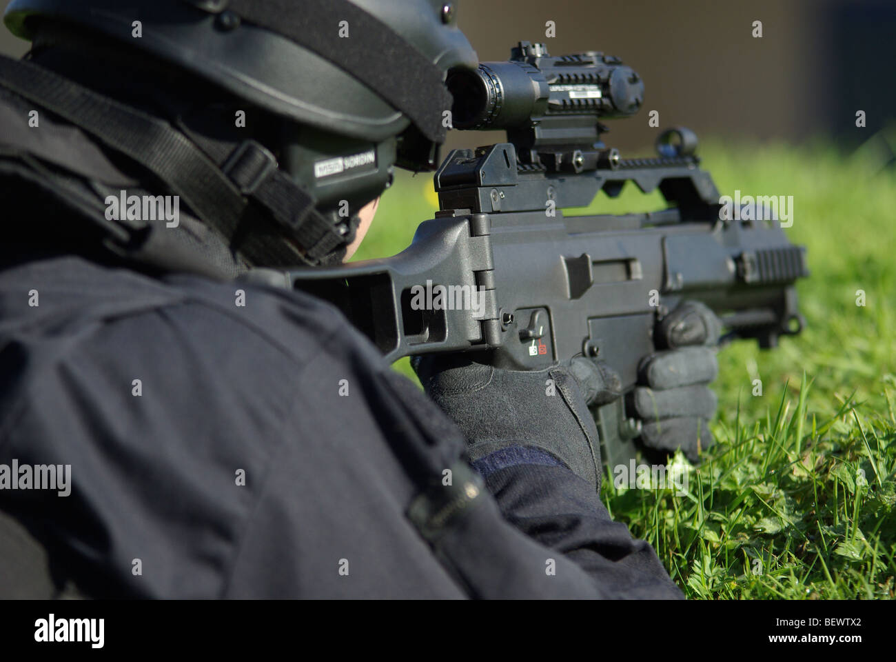 Police firearms officer in containment position Stock Photo