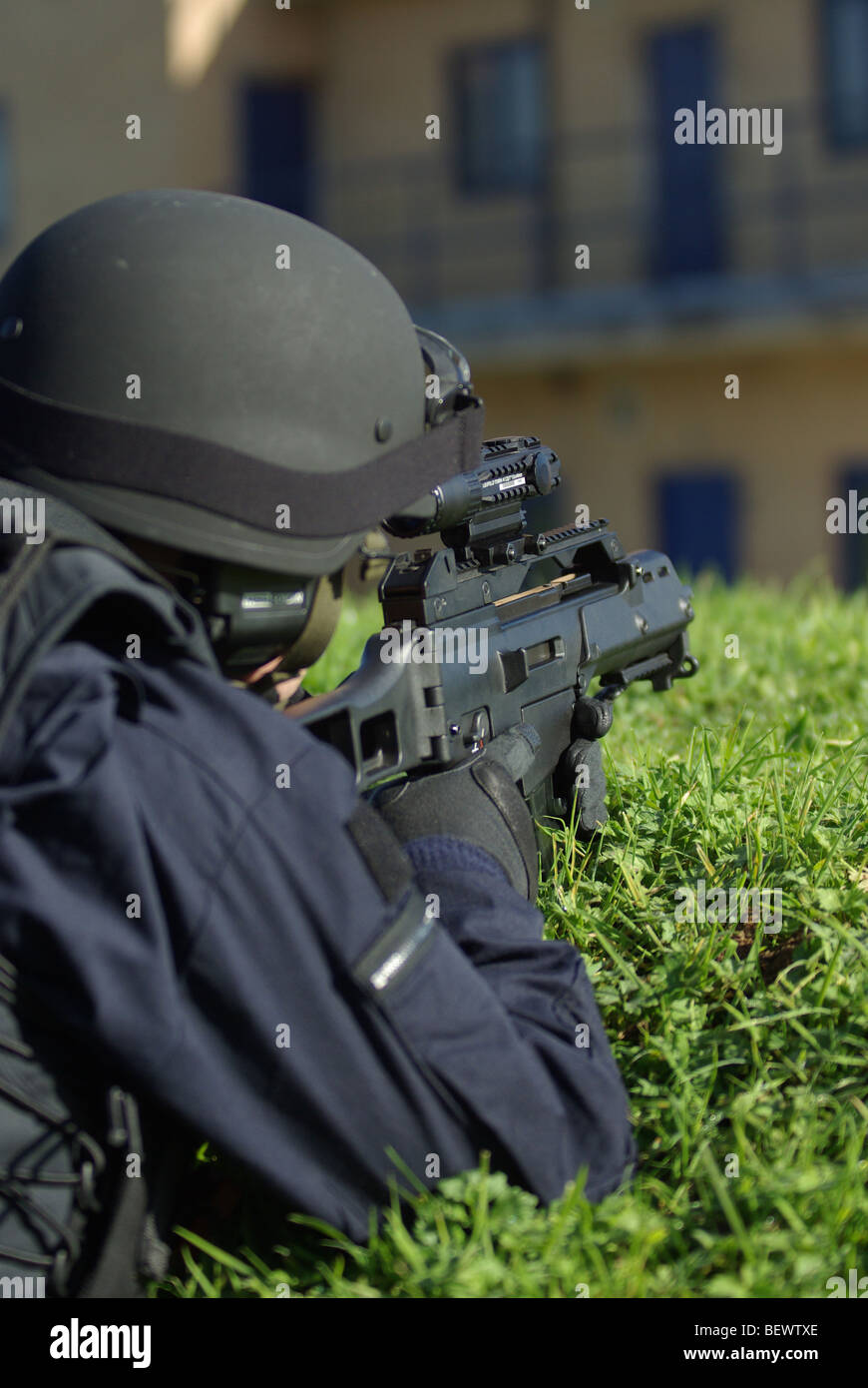 Police firearms officer in containment position Stock Photo