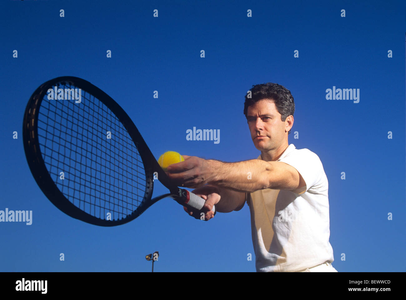 Tennis Player Preparing to Serve Stock Photo