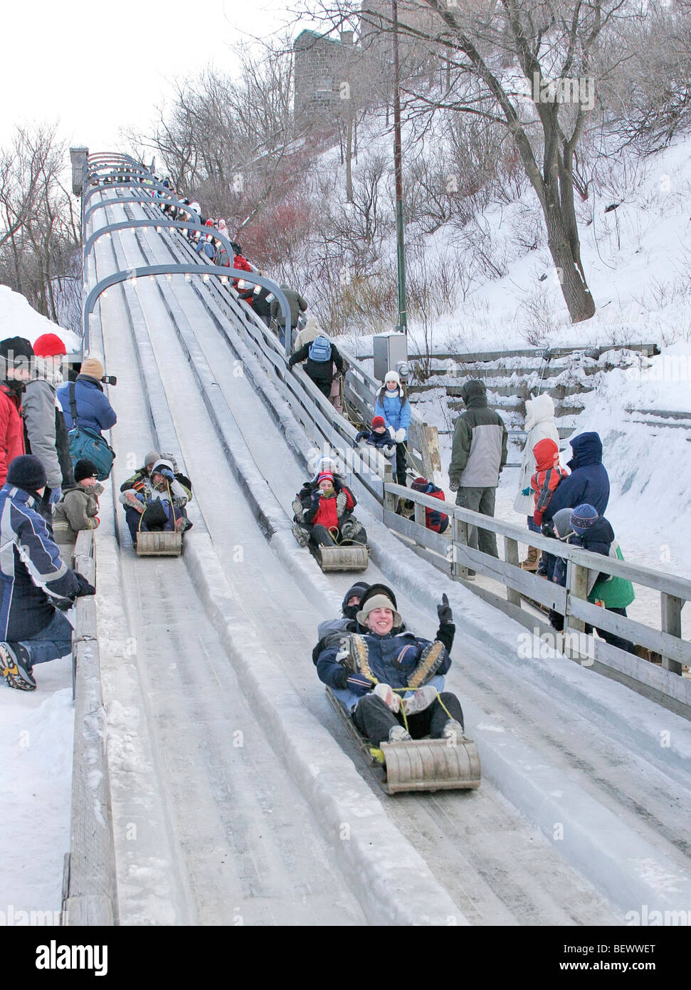 Sliding down ice toboggan run at Dufferin Terrace, boardwalk below