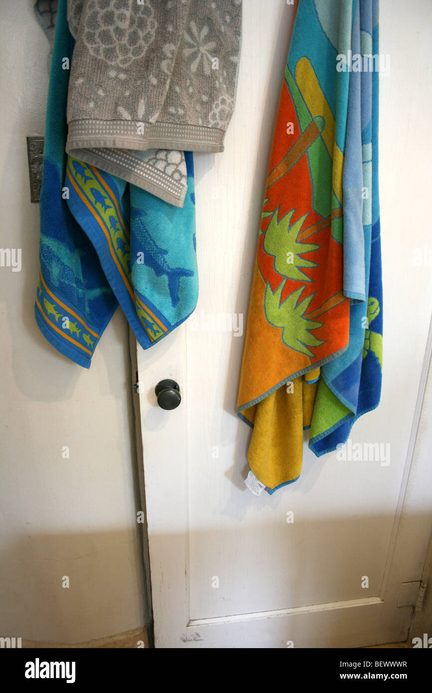towels hanging on bathroom door Stock Photo