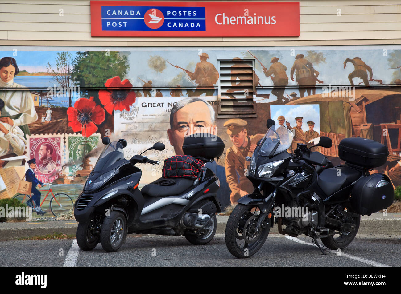 Piaggio MP3-400 scooter and Suzuki Wee Strom 650 motorcycle in front of the  Letters from the Front mural painted in 2002 by Davi Stock Photo - Alamy