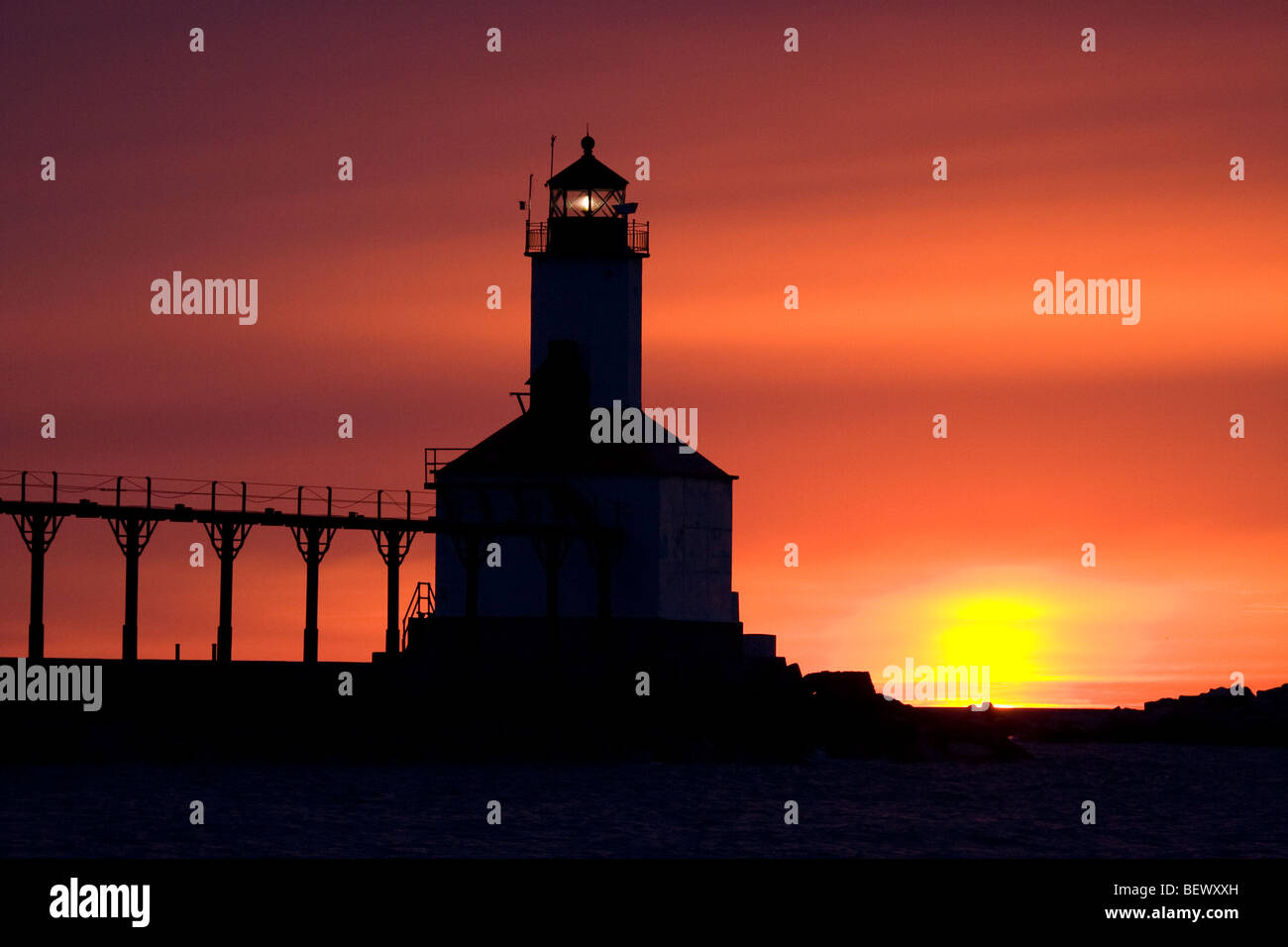 Silhouette of the lighthouse and catwalk in Michigan City Indiana at sunset Stock Photo