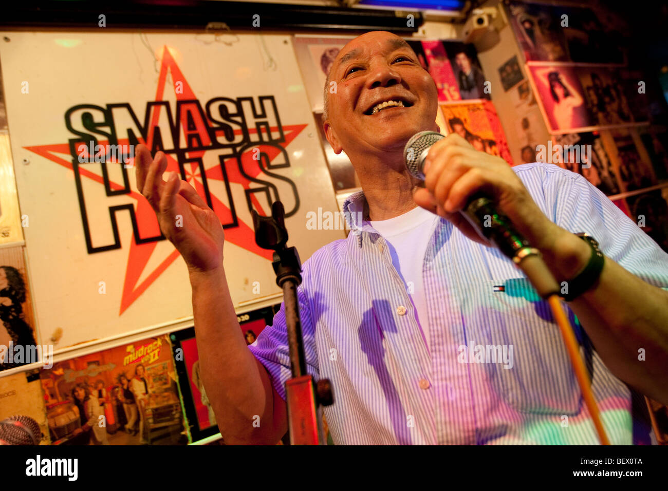 Hide Saito at work in his long established karaoke bar 'Smash Hits', Tokyo, Japan. Stock Photo