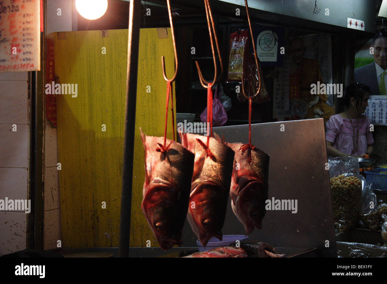 Fish monger and shop amongst many in chinatown Bangkok Stock Photo