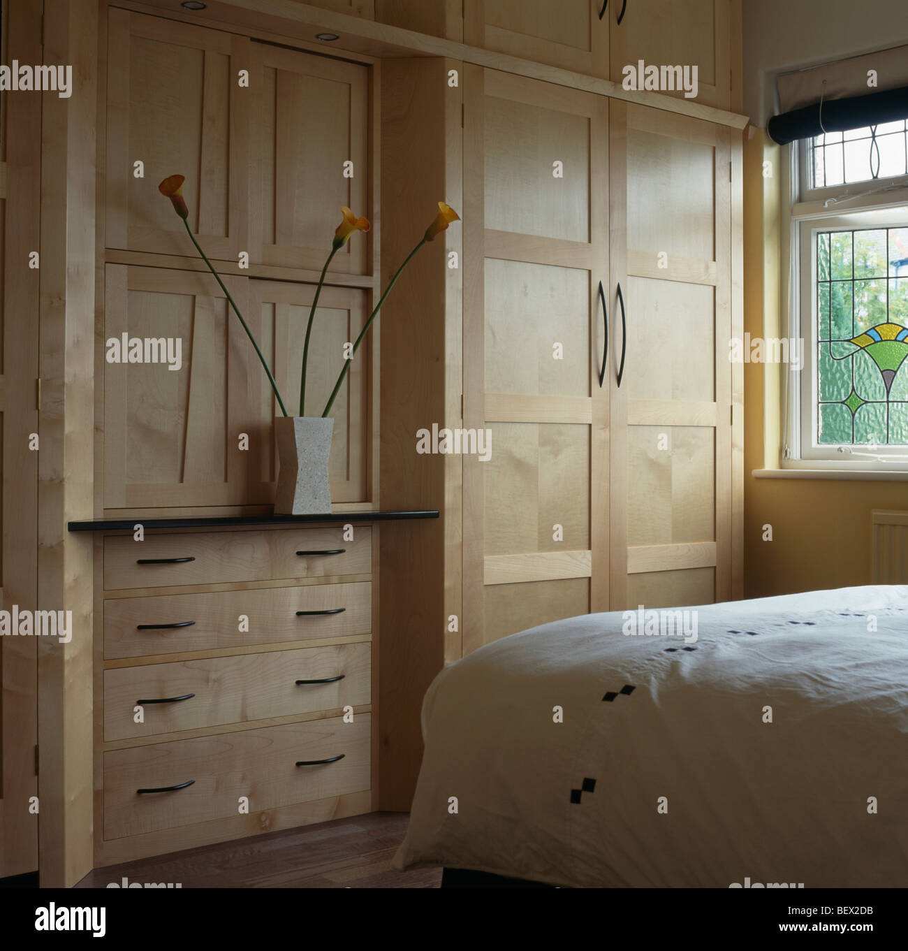 Pale Wood Fitted Wardrobes And Chest Of Drawers In Modern