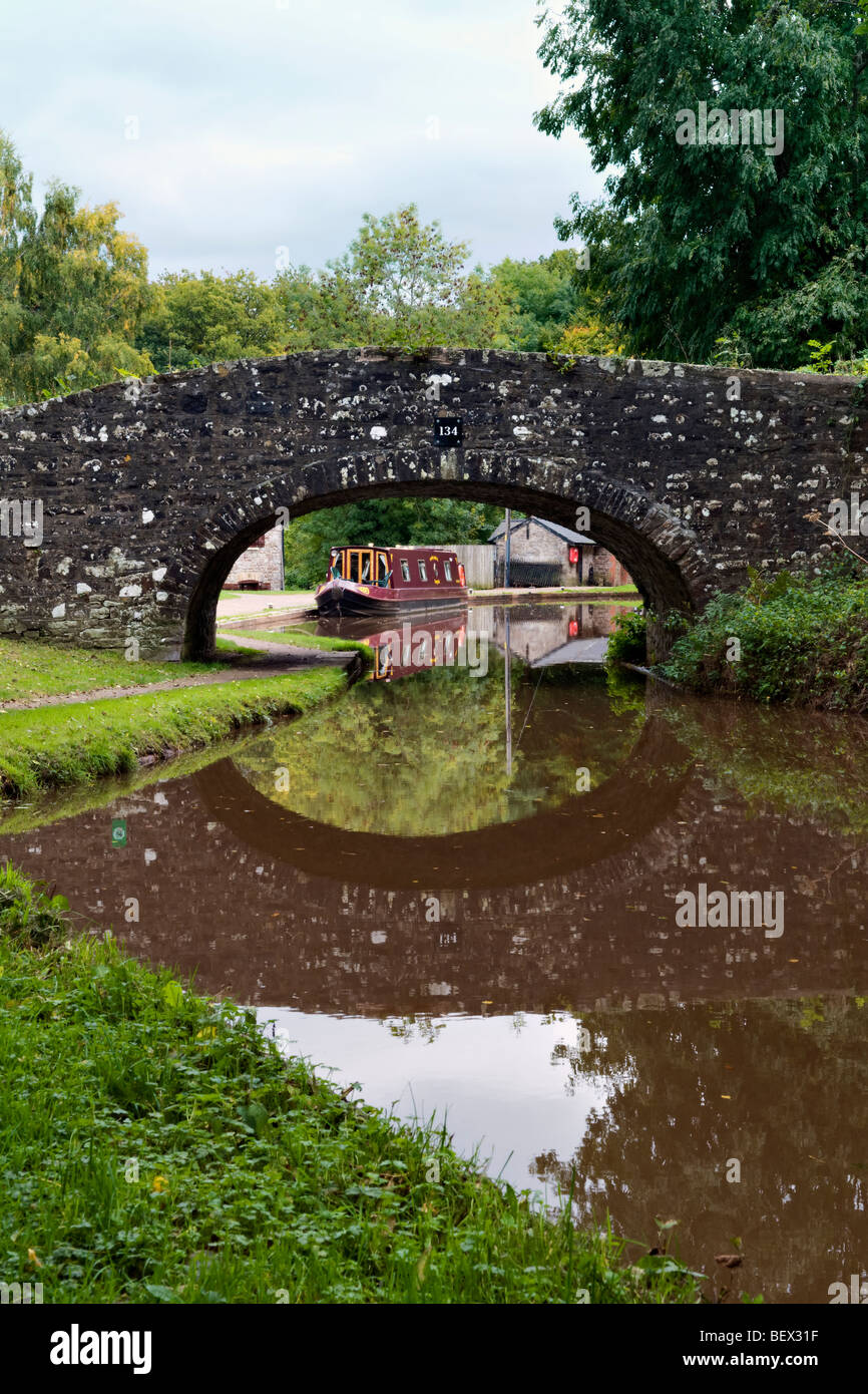 Old stone bridge 134 on the Monmouth and Brecon Canal taken at Llangynidr mid Wales early autumn with perfect still reflection Stock Photo