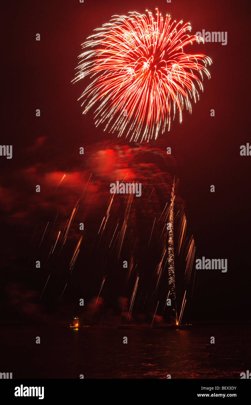 Red fireworks and falling sparks make the sky look like it's on fire