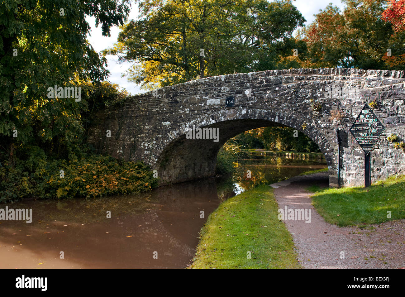 Old stone bridge 134 on the Monmouth and Brecon Canal taken at Llangynidr mid Wales with autumn colours and pretty reflection Stock Photo