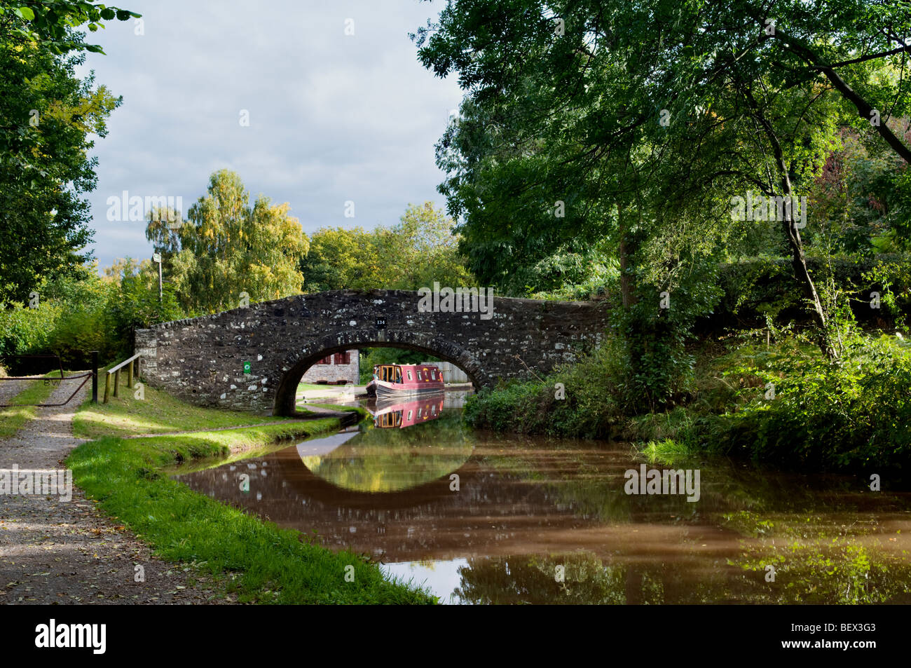 Old stone bridge 134 on the Monmouth and Brecon Canal taken at Llangynidr mid Wales early autumn with perfect still reflection Stock Photo